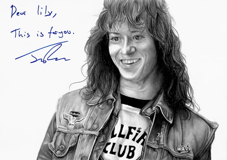 Grayscale high-detailed pencil artwork on a white canvas by Lily K depicting Joseph Quinn as Eddie from Stranger Things, plus Joseph's signature in the upper left with the message, "Dear Lily, This is for you."