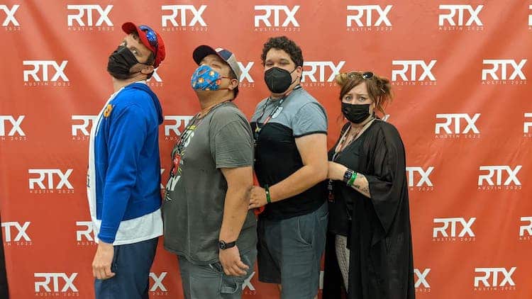 Posed image on a red RTX-branded backdrop of Emmanuel Alejandro with three members of the Funhaus cast all standing in a line partially facing the camera, mimicking a prom photo.