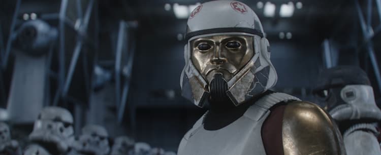 Captain Enoch, a stormtrooper with a golden human-like face on the front of his helmet