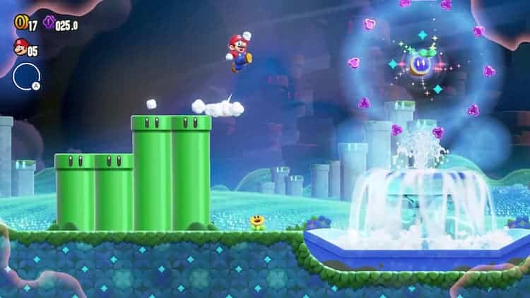 Mario is jumping towards a Wonder Seed. The seed is above a water fountain and is surrounded by purple collectibles. Green pipes can be seen to the left and in the background.