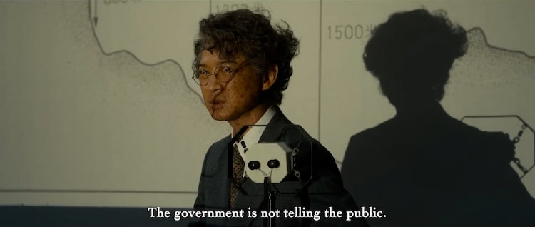 A man standing in front of a map of Tokyo bay.