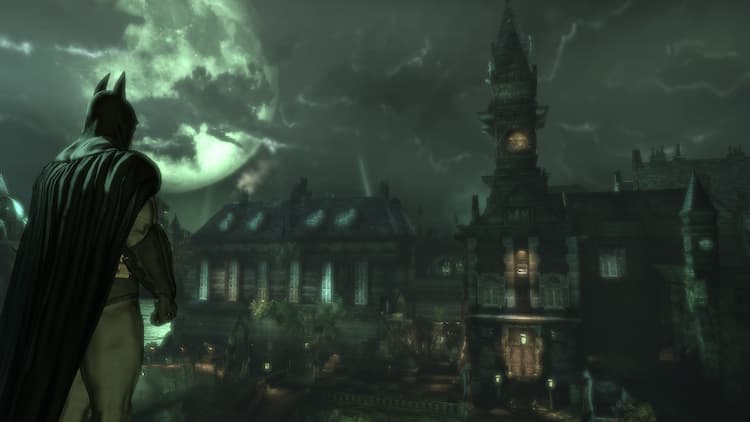 Batman is standing on a cliff overlooking Arkham Island. The Arkham Mansion is in the distance. The full moon can be seen peaking through the clouds.