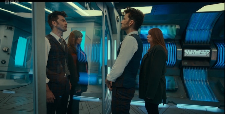 The Doctor and Donna stare down their dopplegangers behind a glass panel