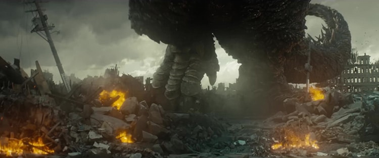 Godzilla’s feet walking through a ruined city