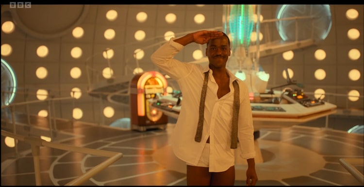 Ncuti gatwa's Doctor salutes in the Tardis with no trousers on.