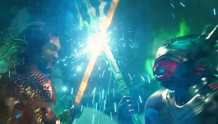 Aquaman and Black Manta are fighting. They are both wielding tridents and are clashing in the middle. The background has a green hue to it.